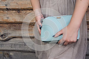 Woman holding blue handbag