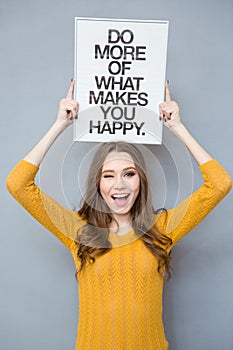 Woman holding board with text and winking