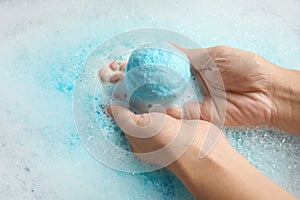 Woman holding bomb in color water