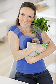 Woman holding bonsai tree