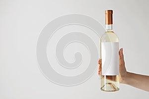 Woman holding bottle with delicious wine