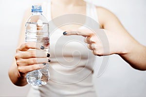 Woman holding bottle of water in her hand