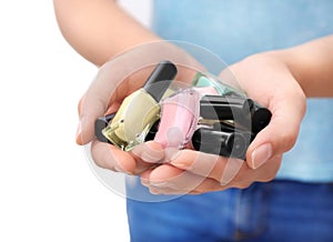 Woman holding bottles of colorful nail polishes, closeup