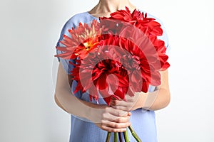 Woman holding bouquet of beautiful dahlia flowers