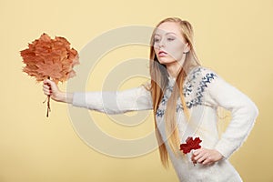 Woman holding bouquet made of autumn leaves