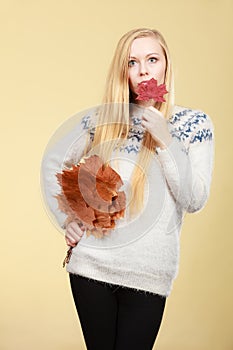 Woman holding bouquet made of autumn leaves