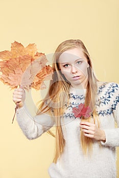 Woman holding bouquet made of autumn leaves