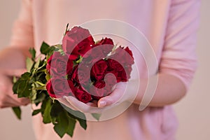 Woman holding a bouquet of red roses background usable