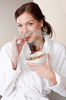 Woman holding bowl with cereals for breakfast