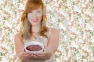 Woman holding bowl of pomegranate seeds
