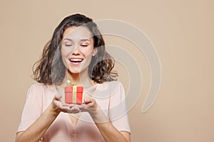 woman is holding a box with a gift for Christmas or birthday, a surprise. sale, poster for a cosmetics or jewelry store