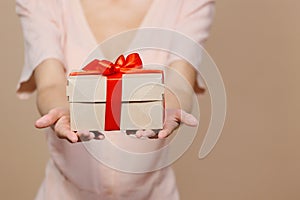 woman is holding a box with a gift for Christmas or birthday, a surprise. sale, poster for a cosmetics or jewelry store