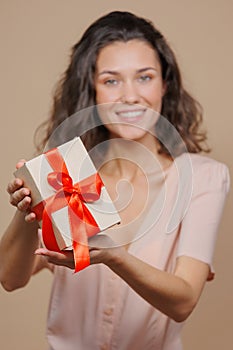 woman is holding a box with a gift for Christmas or birthday, a surprise. sale, poster for a cosmetics or jewelry store