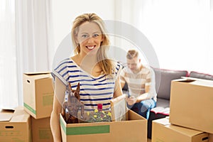 Woman holding box with objects