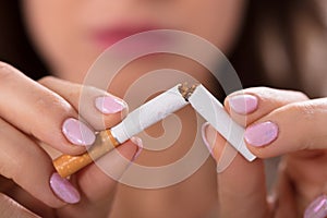 Woman Holding Broken Cigarette
