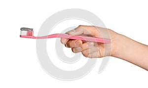 Woman holding brush with charcoal toothpaste against white background, closeup