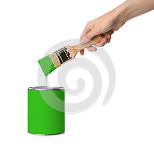 Woman holding brush over green paint can