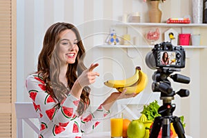 Woman holding bunch of bananas