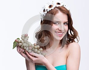 Woman holding bunch of grapesand