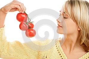 Woman holding bunch of tomatoes