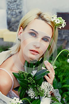 Woman holding bunch of wildflowers