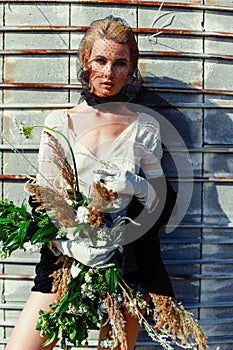 Woman holding bunch of wildflowers