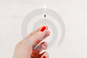 Woman holding a burning match