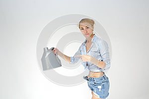 Woman holding canister of motor oil on light background