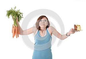 Woman holding carrots and cake healthy nutrition