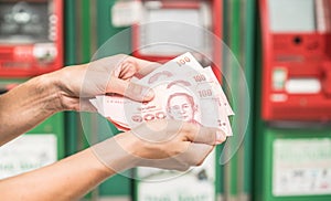 Woman holding cash withdrawn from ATM