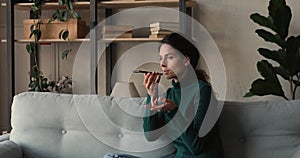 Woman holding cellphone making call speaking on speakerphone