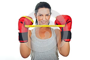 Woman holding centimeter between gloves