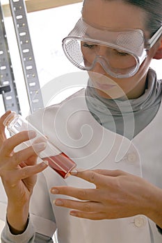 Woman holding chemical flask