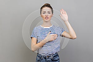 Woman holding on chest another, swearing in honesty and devotion, patriotism