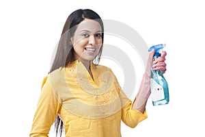Woman holding cleaning spray bottle