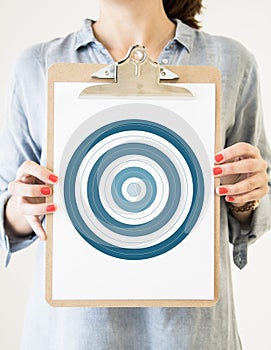 woman holding clipboard with bullseye