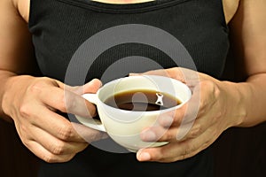 Woman holding coffee cup in her hand