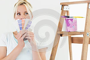 Woman holding color swatches in new house