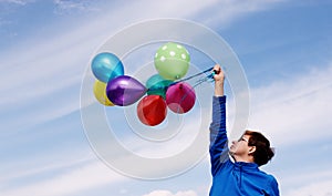 Woman holding colorful balloons