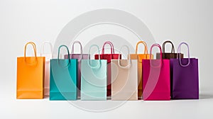 Woman holding colorful paper shopping bags on white background for vibrant shopping experience