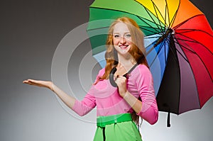 Woman holding colourful umbrella