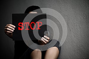 A woman holding a conceptual stop sign on violence against women