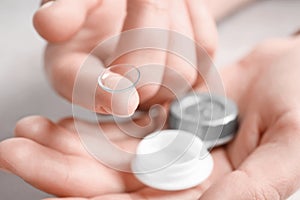 Woman holding contact lens and case