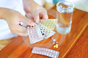 Woman holding contraception pills in hand - Birth control contraceptive prevent pregnancy hormonal oral contraceptives