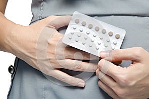 Woman holding contraceptive pills protect for pregnant