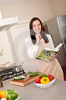 Woman holding cookbook woman in the kitchen