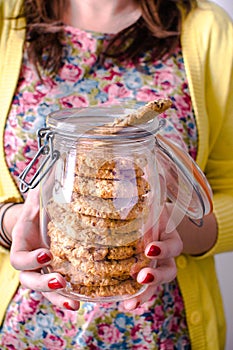 Woman holding cookie jar with cookies