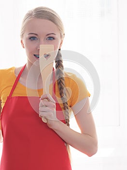 Woman holding cooking pan and spatula