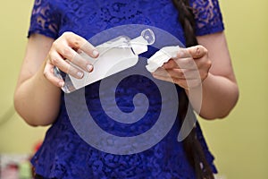 Woman holding cotton swab and makeup remover in hands. Make up remove skin care. Closeup woman holding cotton swab and makeup remo