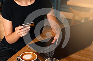 Woman holding credit card on laptop for online shopping